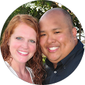 smiling young man and woman with their heads touvhing