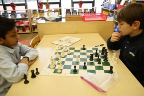 two kids playing chess