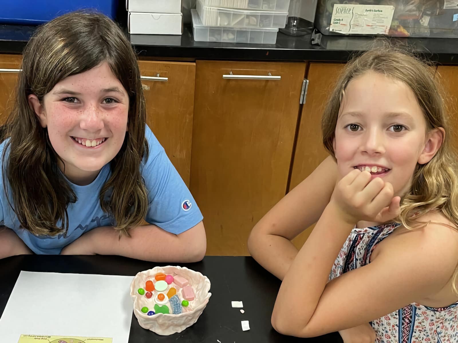 two young girls smiling at the camera
