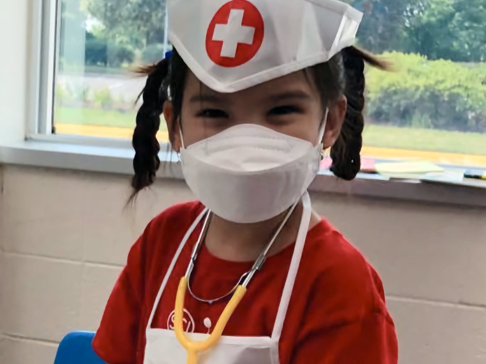 Little girl wearing doctor dress up clothes