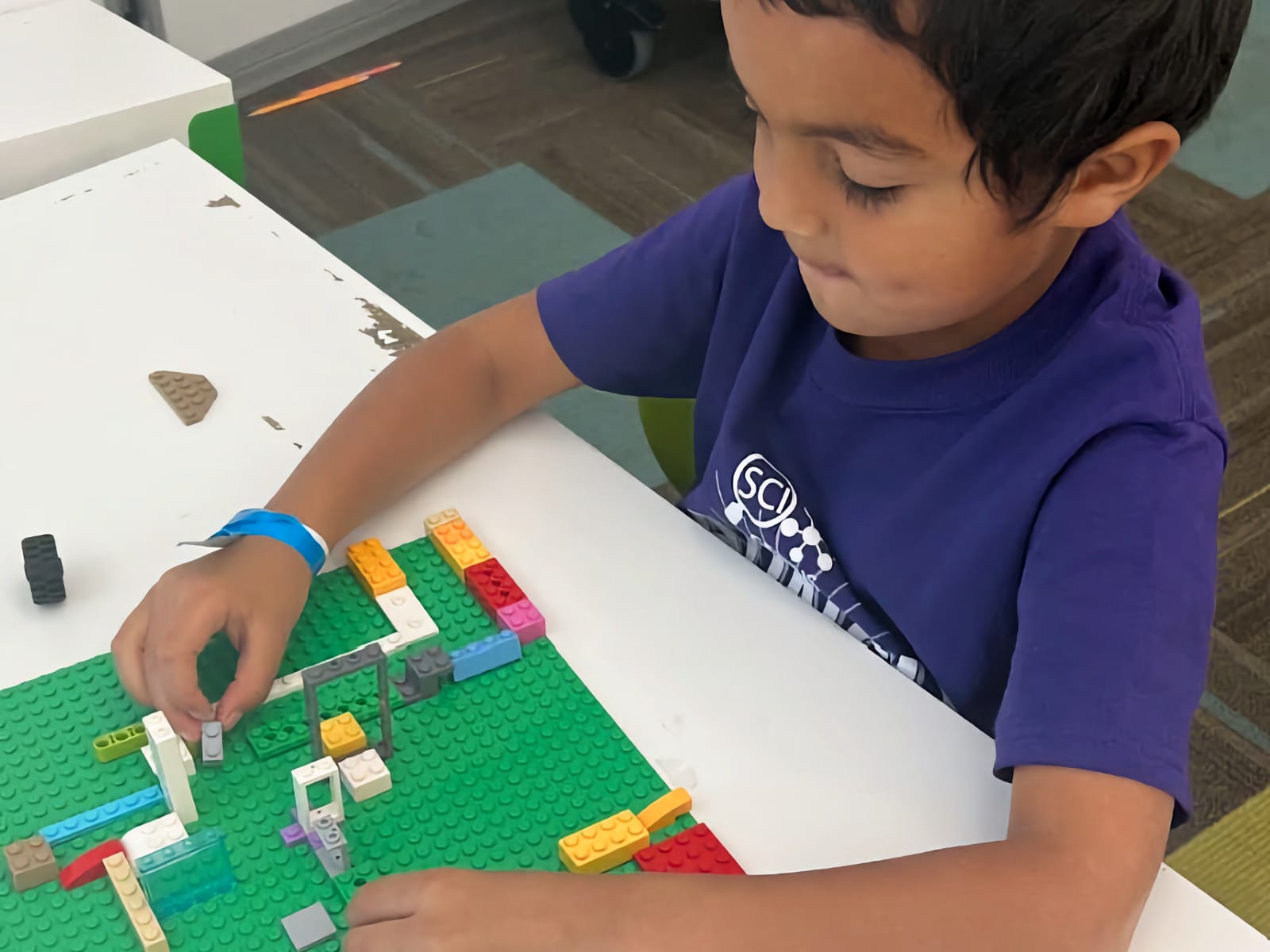 young boy building with LEGO
