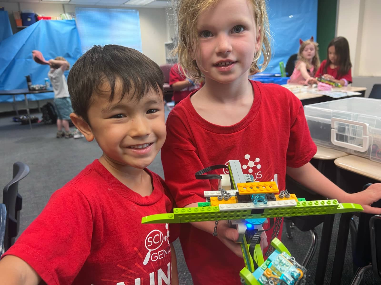 boy and girl with LEGO robot