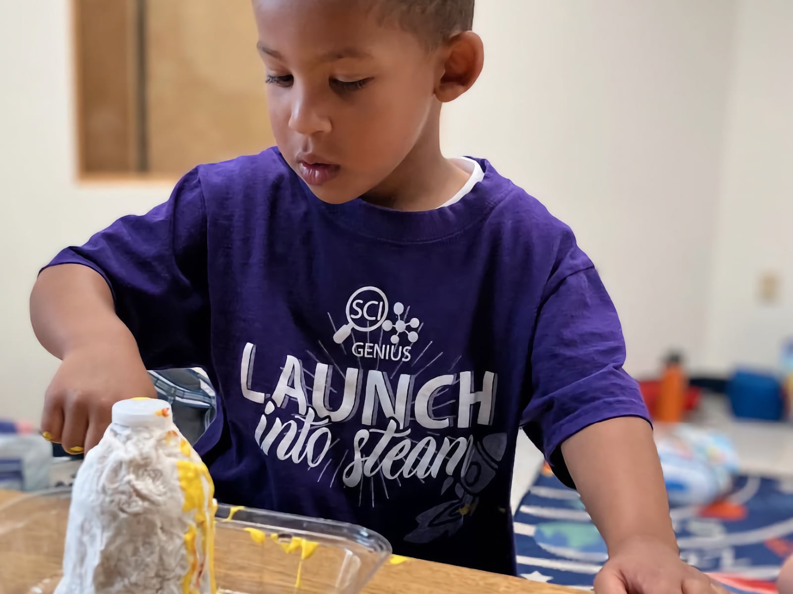 young boy making a volcano experiment