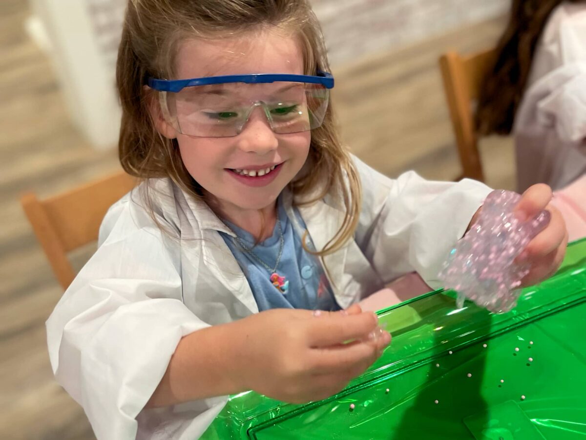 excited girl playing with slime