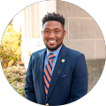 handsome smiling man wearing a navy suit and tie