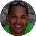 smiling man with sunglasses on head