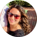 young smiling woman with long wavy hair and sunglasses